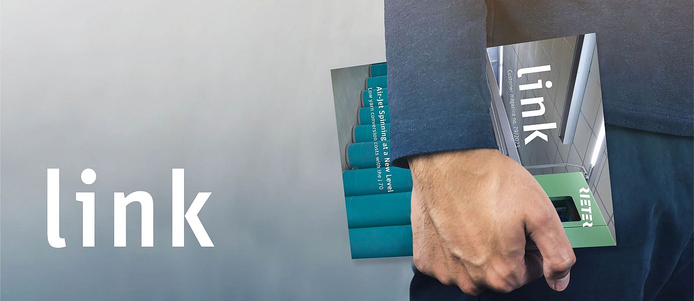 Hand holding an issue of Rieter's Customer Magazine "link"